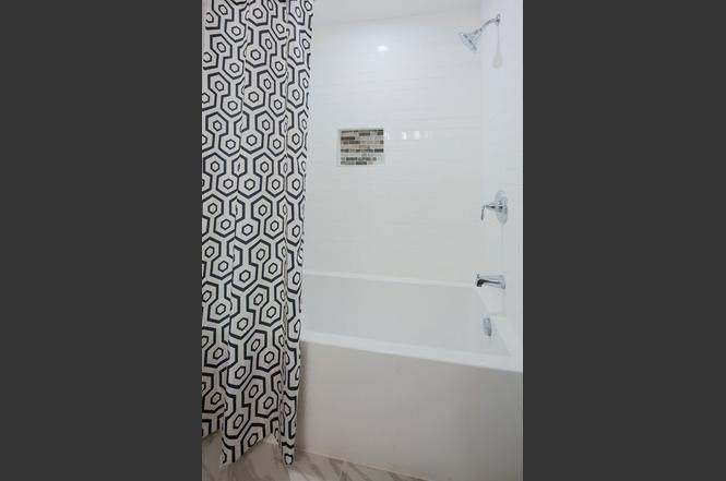 93 Calvary Street, Unit 2 Waltham, MA 02453 - Photo 28 of 33 a bathroom with a bathtub and shower