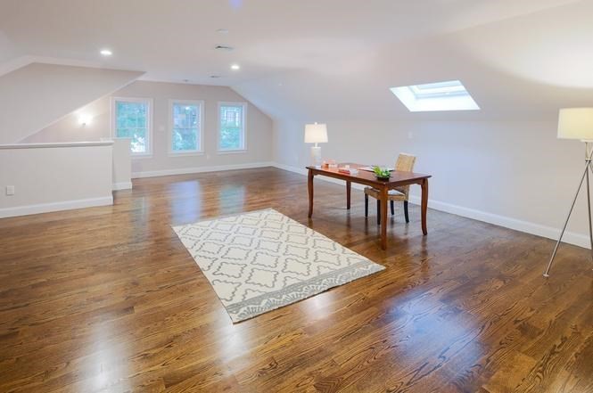 93 Calvary Street, Unit 2 Waltham, MA 02453 - Photo 30 of 33 a living room with furniture and a wooden floor