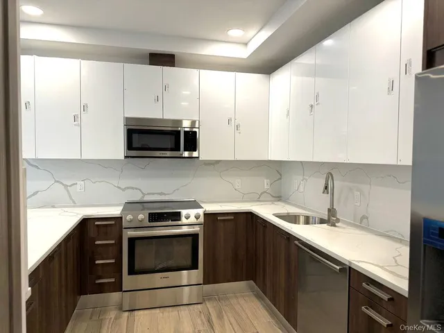 a kitchen with a sink stove and microwave