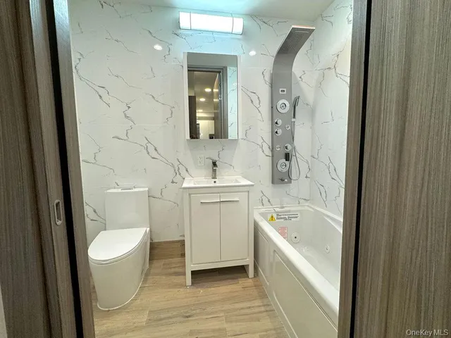 a bathroom with a sink toilet and shower