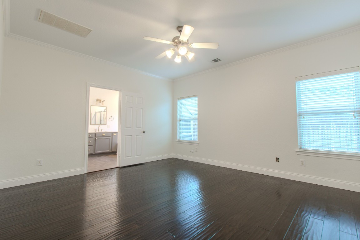 21906 Trapper Lake Drive Spring, TX 77388 - Photo 12 of 21 A spacious primary retreat downstairs with more thoughtful touches like crown molding and a ceiling fan.
