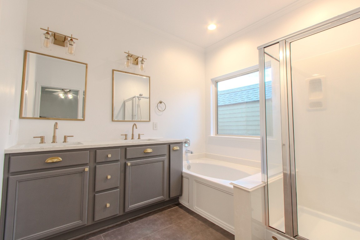 21906 Trapper Lake Drive Spring, TX 77388 - Photo 13 of 21 Your days will begin beautifully at this sleek vanity with the luxury of a soaking tub or the convenience of a glass-enclosed shower.