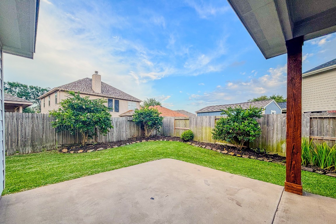 21906 Trapper Lake Drive Spring, TX 77388 - Photo 20 of 21 Mornings or evenings will be enjoyable out on the back patio with pretty landscaping in view.