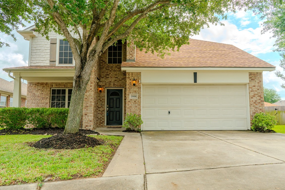 21906 Trapper Lake Drive Spring, TX 77388 - Photo 2 of 21 Noticing the widened driveway and details like gutters and decorative shutters.