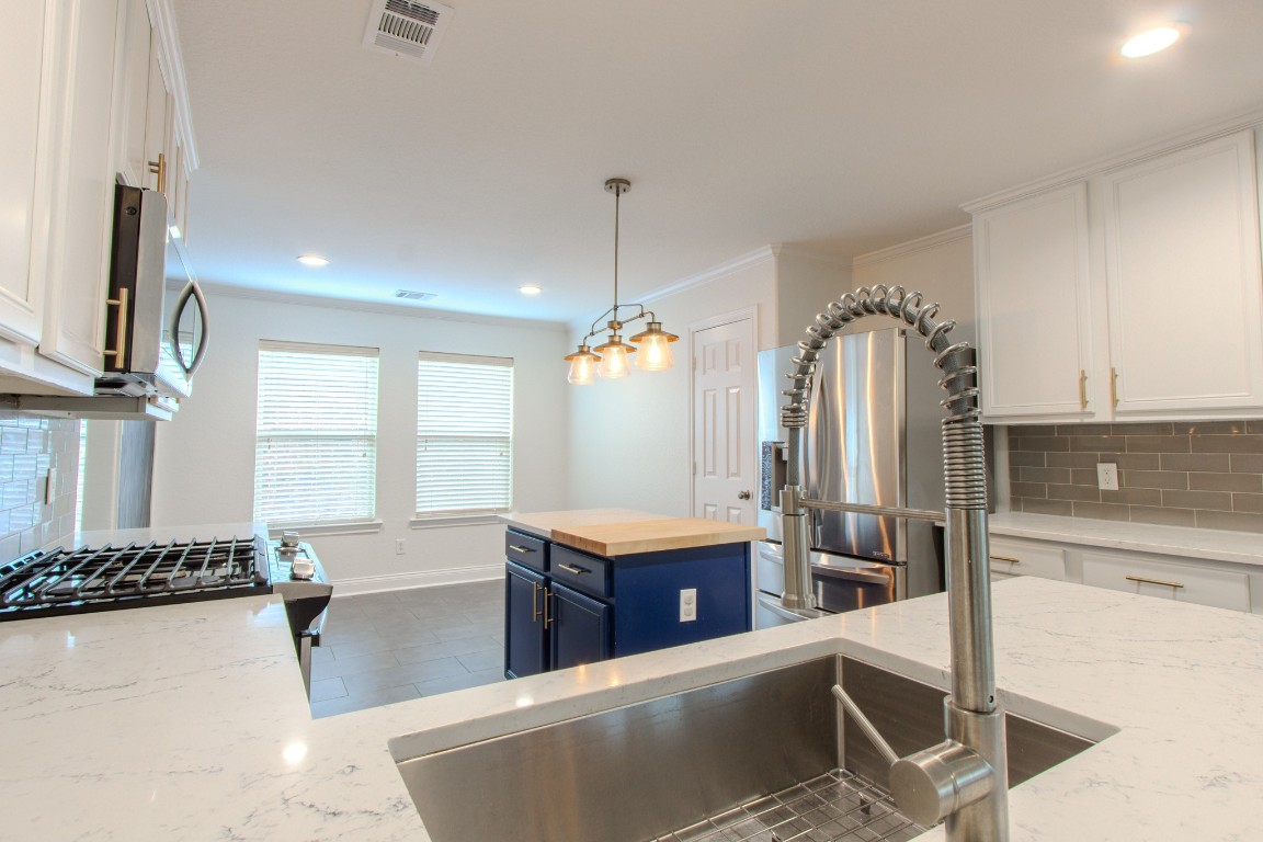 21906 Trapper Lake Drive Spring, TX 77388 - Photo 9 of 21 The quartz countertops are gorgeous, and notice the upgraded sink, faucet and appliances!