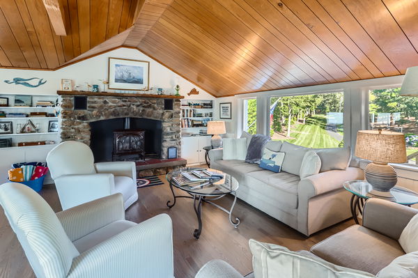 217 Barnes Road Oak Bluffs, MA 02557 - Photo 21 of 60 a living room with furniture a fireplace and a large window