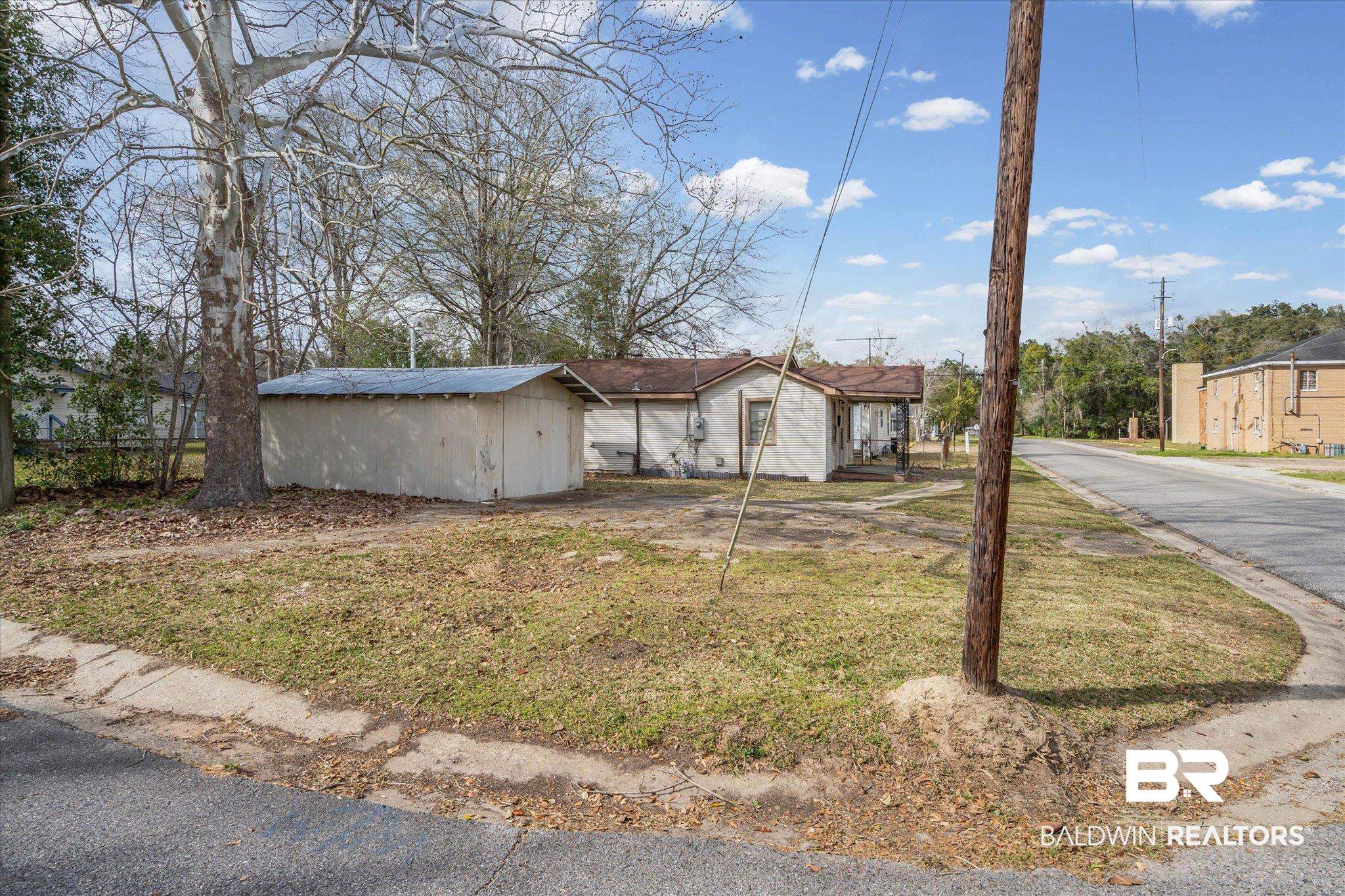351 Kansas Street Mobile, AL 36611 - Photo 2 of 7 View of front of home with a storage unit and a front lawn