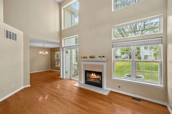 a view of an empty room with a fireplace and a window