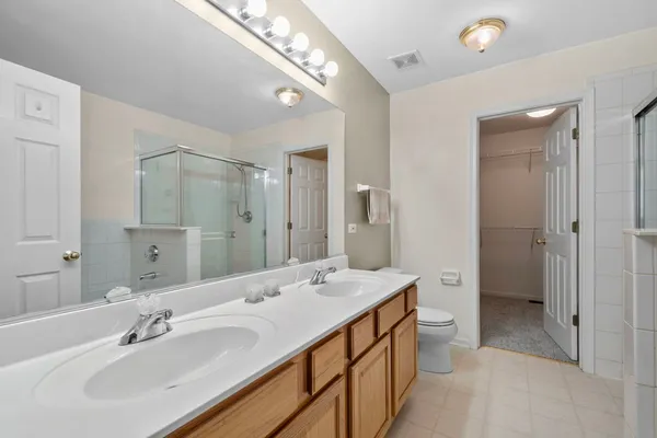 a spacious bathroom with a double vanity sink mirror and double