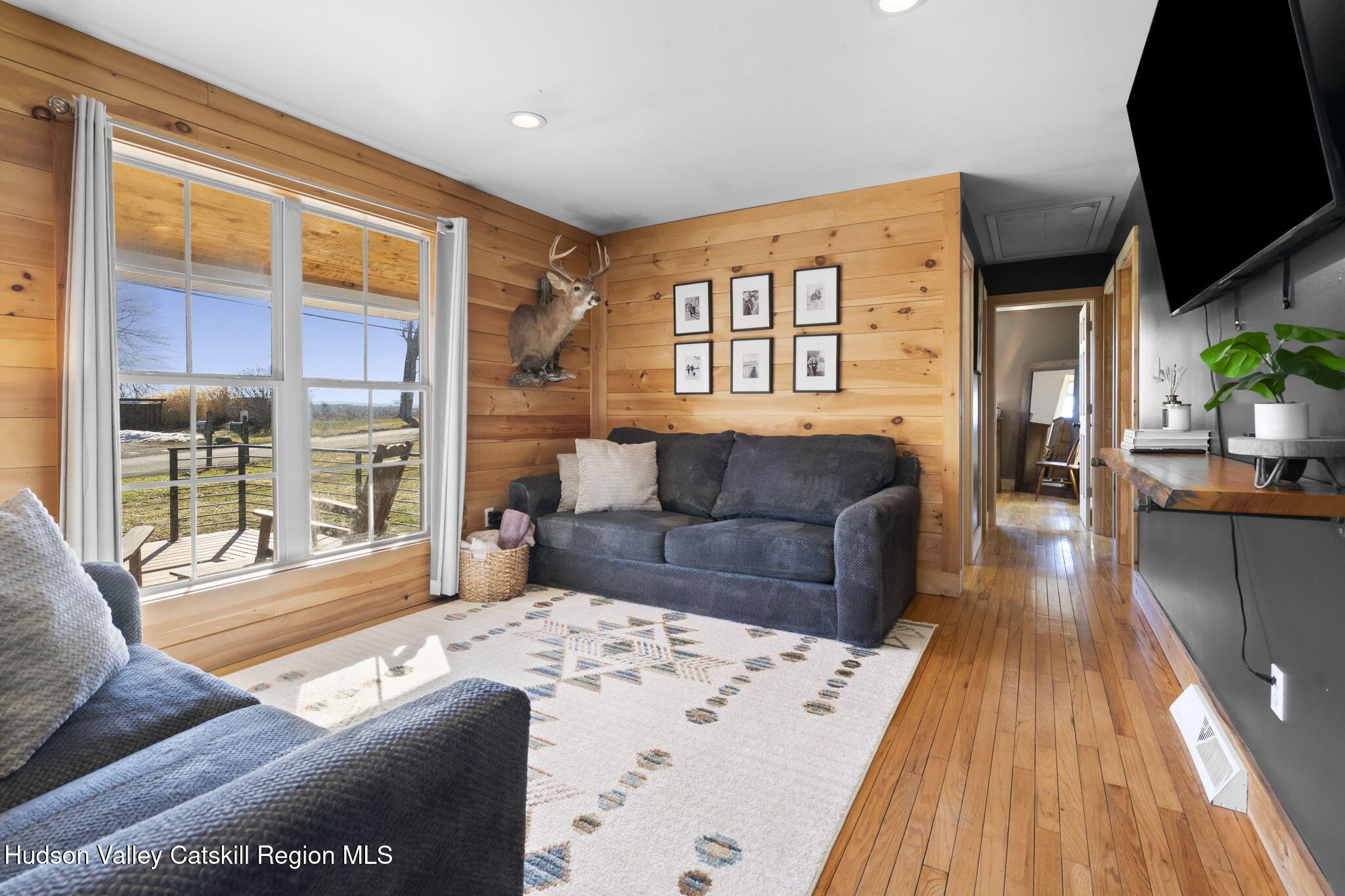 437 Sharptown Road Stuyvesant, NY 12173 - Photo 13 of 39 a living room with furniture and a large window