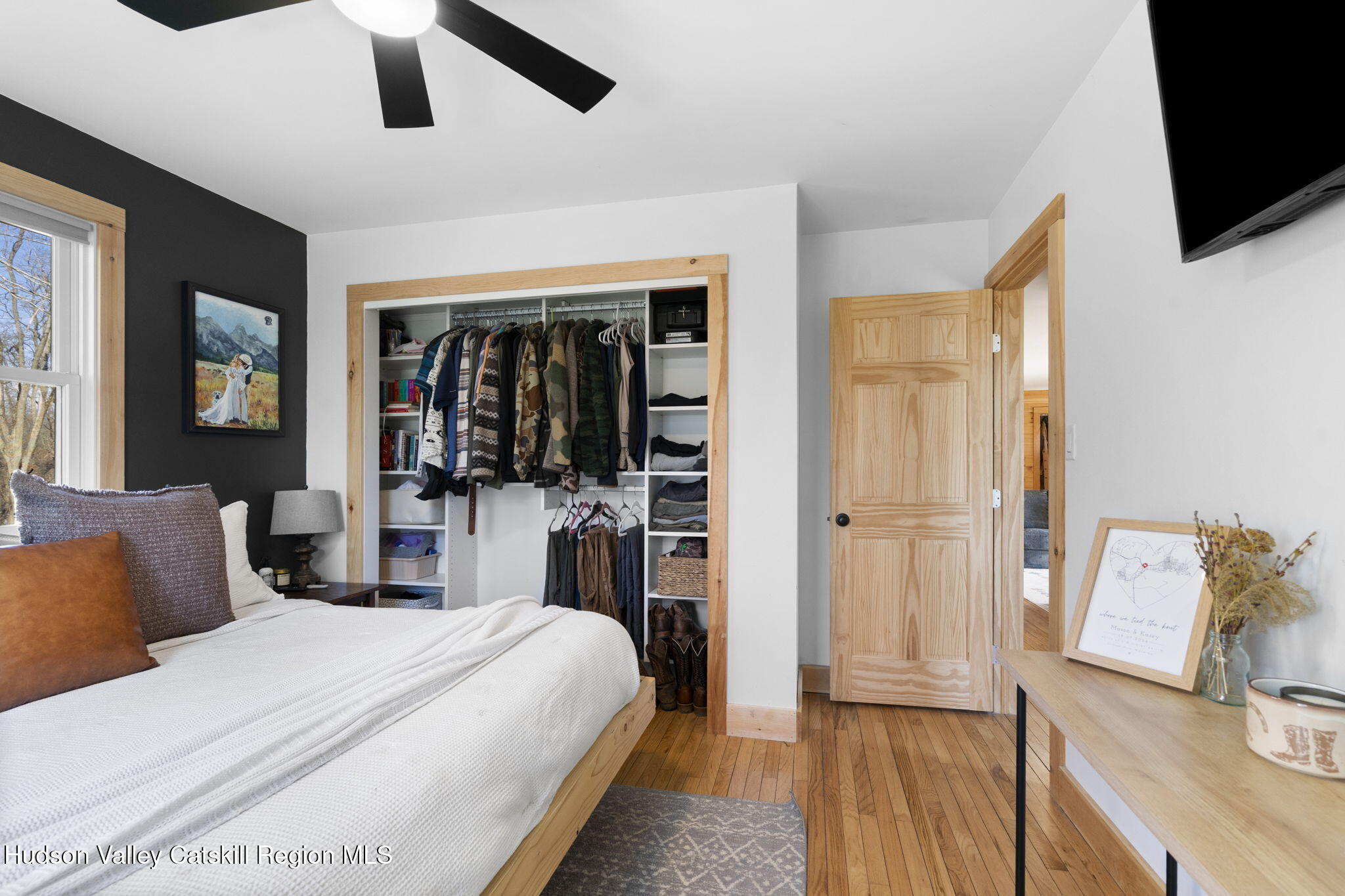 437 Sharptown Road Stuyvesant, NY 12173 - Photo 19 of 39 a bedroom with a bed wooden floor and flat screen tv