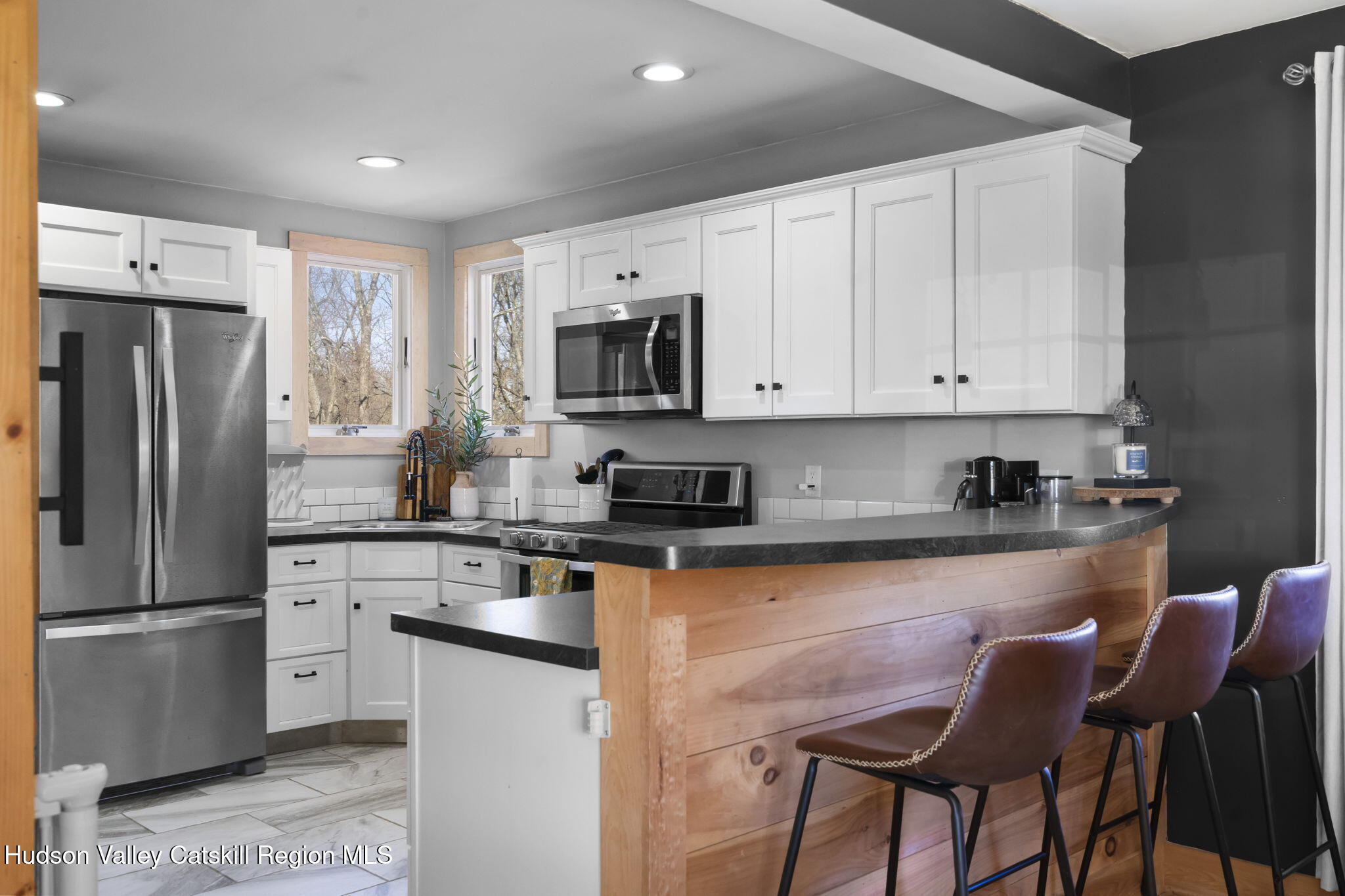 437 Sharptown Road Stuyvesant, NY 12173 - Photo 7 of 39 a kitchen with stainless steel appliances granite countertop a stove a sink a microwave a refrigerator and white cabinets