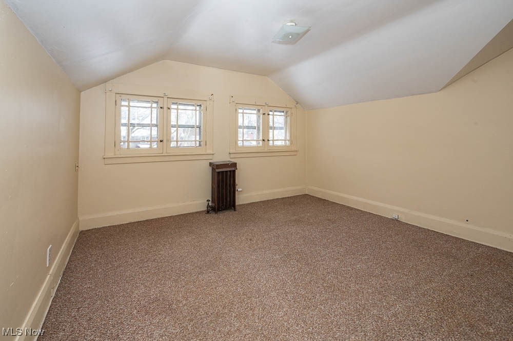 3114 Neosho Road Youngstown, OH 44511 - Photo 17 of 25 Bonus room featuring carpet flooring, lofted ceiling, and radiator heating unit