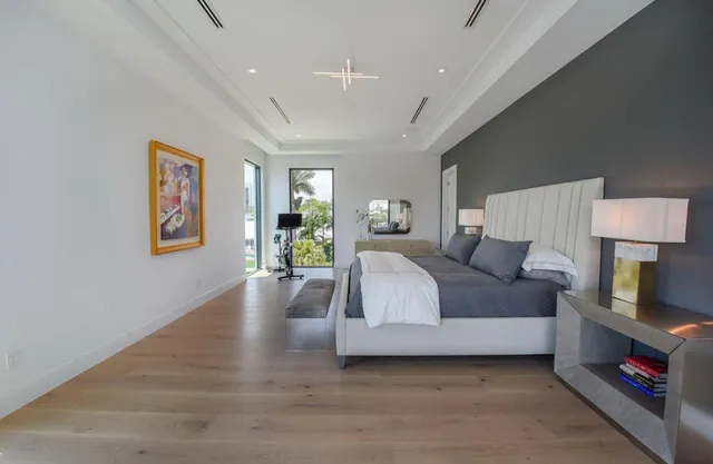 a spacious bedroom with a bed and a couch