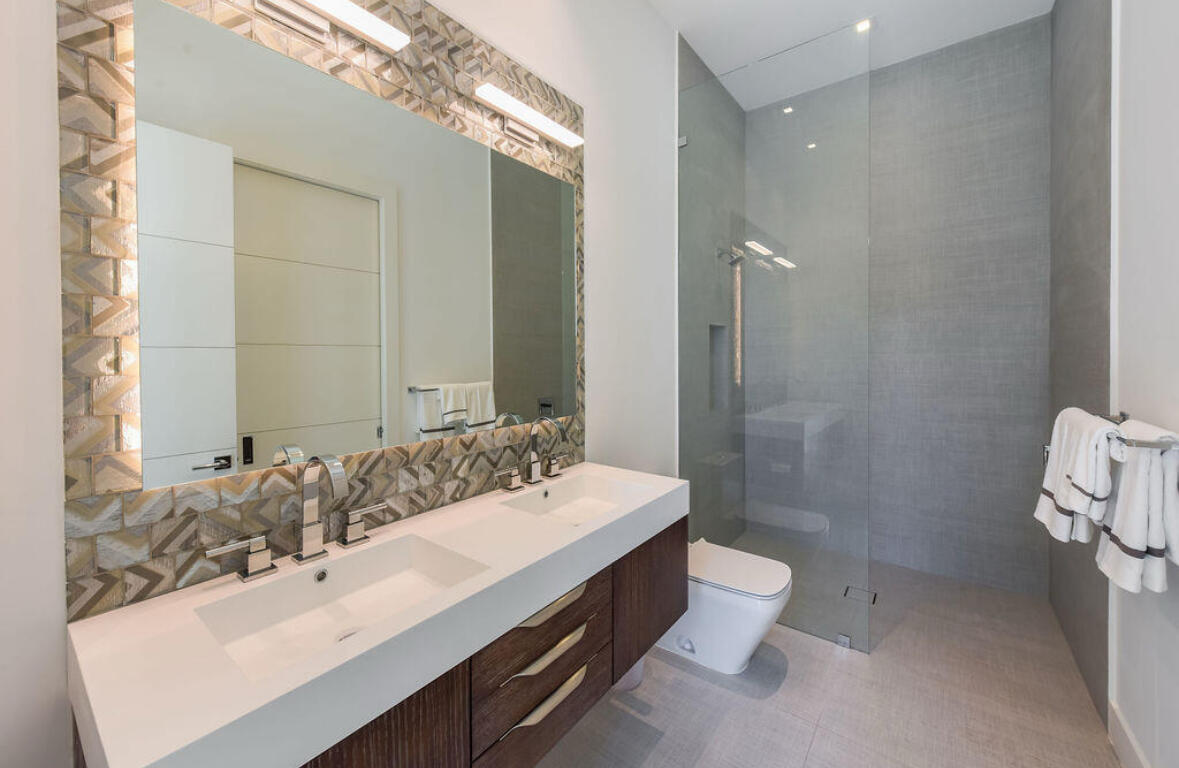 718 Southeast 7th Street Delray Beach, FL 33483 - Photo 15 of 25 a bathroom with a double vanity sink mirror double and toilet