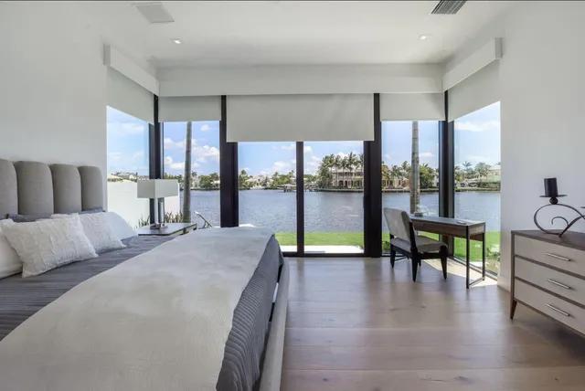 a living room with furniture and a floor to ceiling window