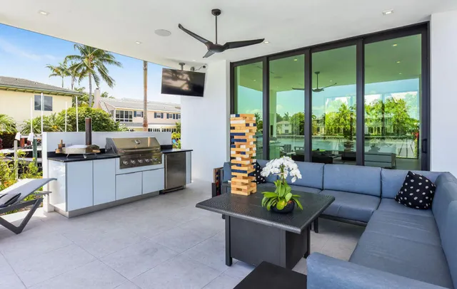 a living room with furniture a flat screen tv and a large window