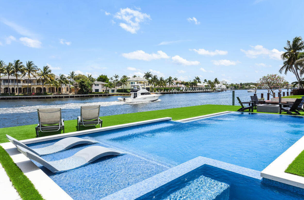 718 Southeast 7th Street Delray Beach, FL 33483 - Photo 24 of 25 a view of a lake with couches chairs in the patio