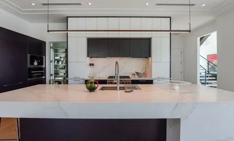 a kitchen with kitchen island sink stove and refrigerator