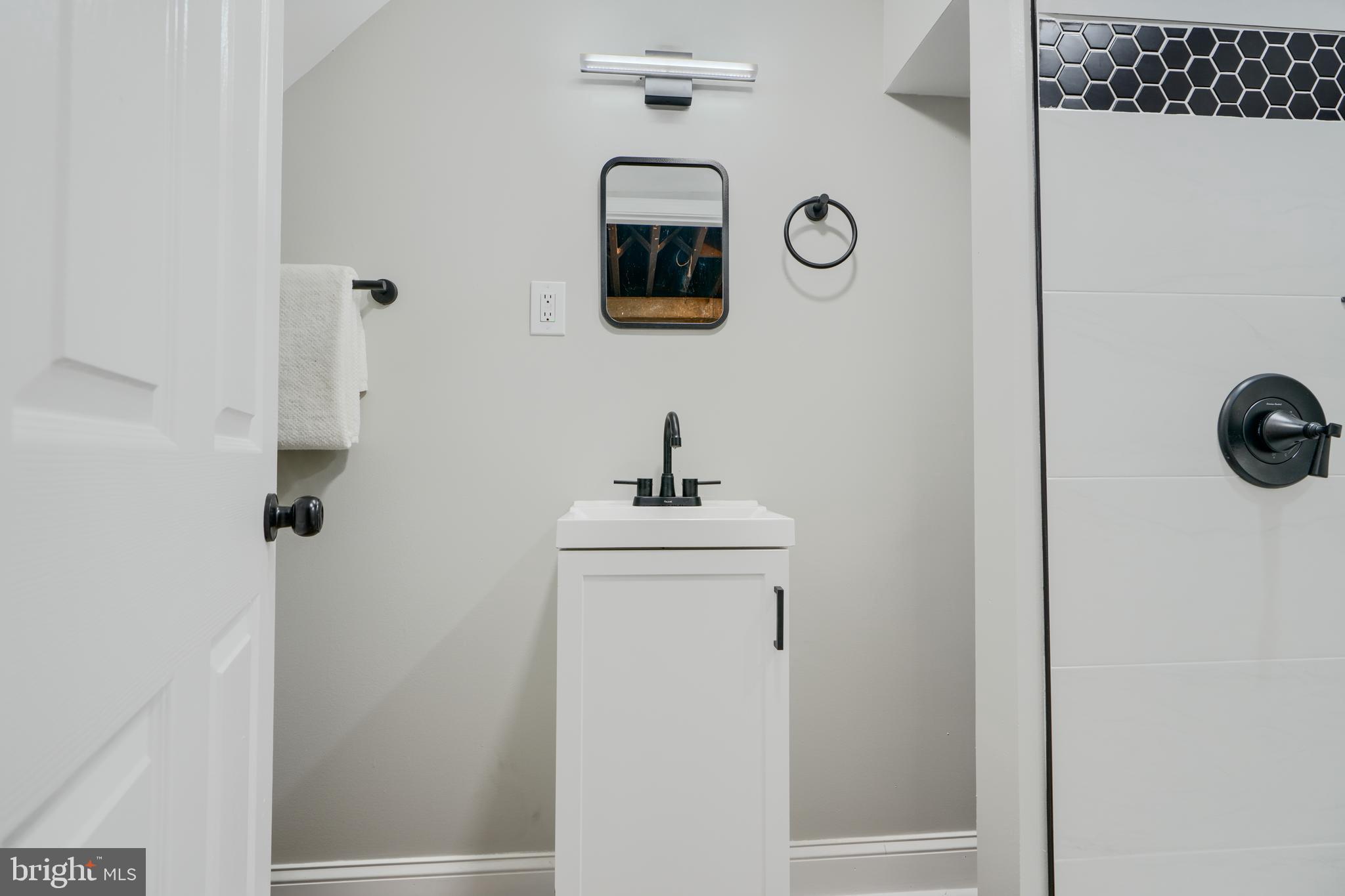 1944 Quentin Road Dundalk, MD 21222 - Photo 31 of 41 a bathroom with a sink and a mirror