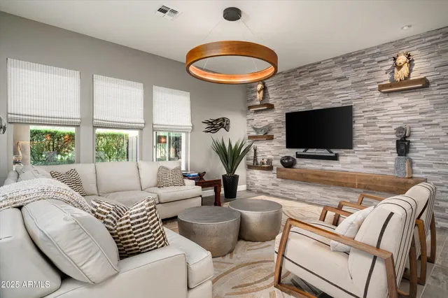 a kitchen with stainless steel appliances kitchen island granite countertop a refrigerator and a stove top oven