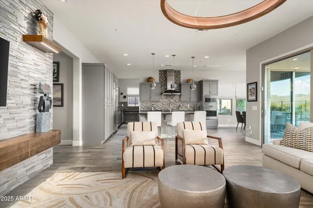 a kitchen with stainless steel appliances kitchen island granite countertop a stove a sink a oven a dining table and chairs