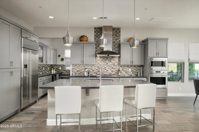 a kitchen with stainless steel appliances granite countertop a sink stove and refrigerator