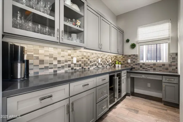 a dining room with furniture a chandelier and wooden floor