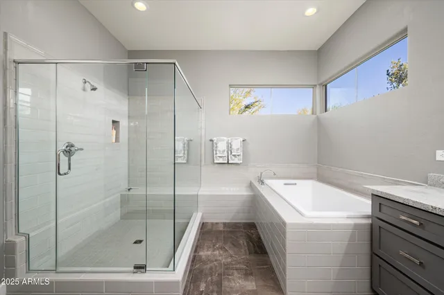 a bathroom with a granite countertop sink a toilet and shower