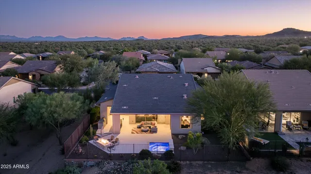 a view of a dining room with furniture chandelier and a large window