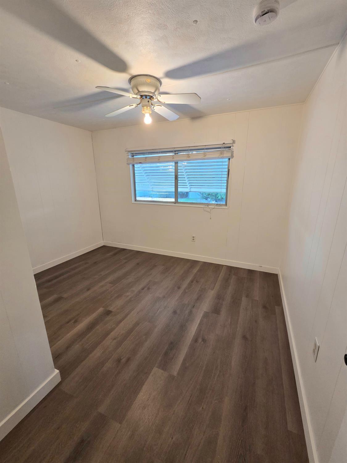 5200 Cavitt Stallman Road, Unit 1 Granite Bay, CA 95746 - Photo 15 of 41 an empty room with wooden floor fan and windows