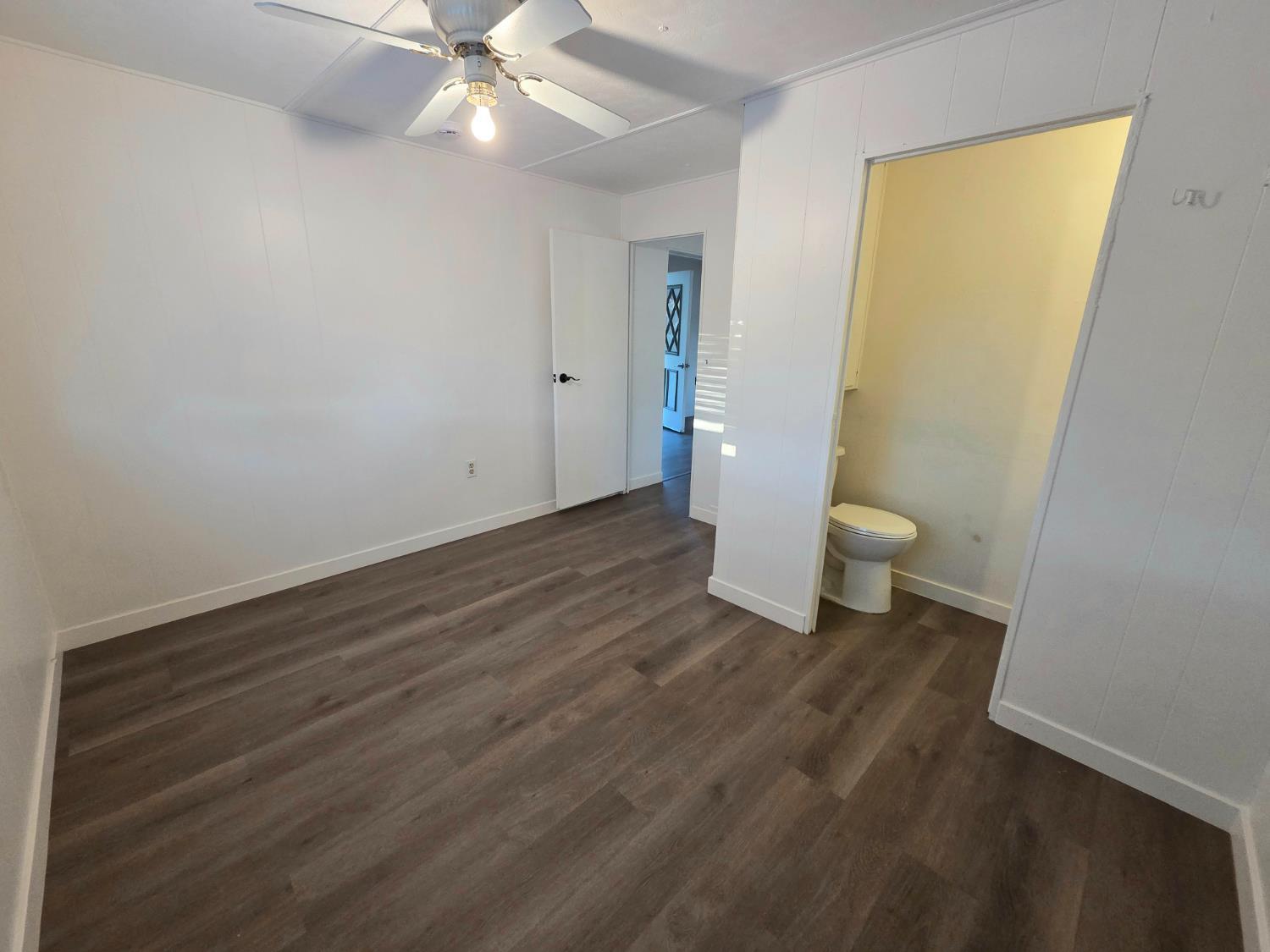 5200 Cavitt Stallman Road, Unit 1 Granite Bay, CA 95746 - Photo 16 of 41 a view of a room with wooden floor and a ceiling fan