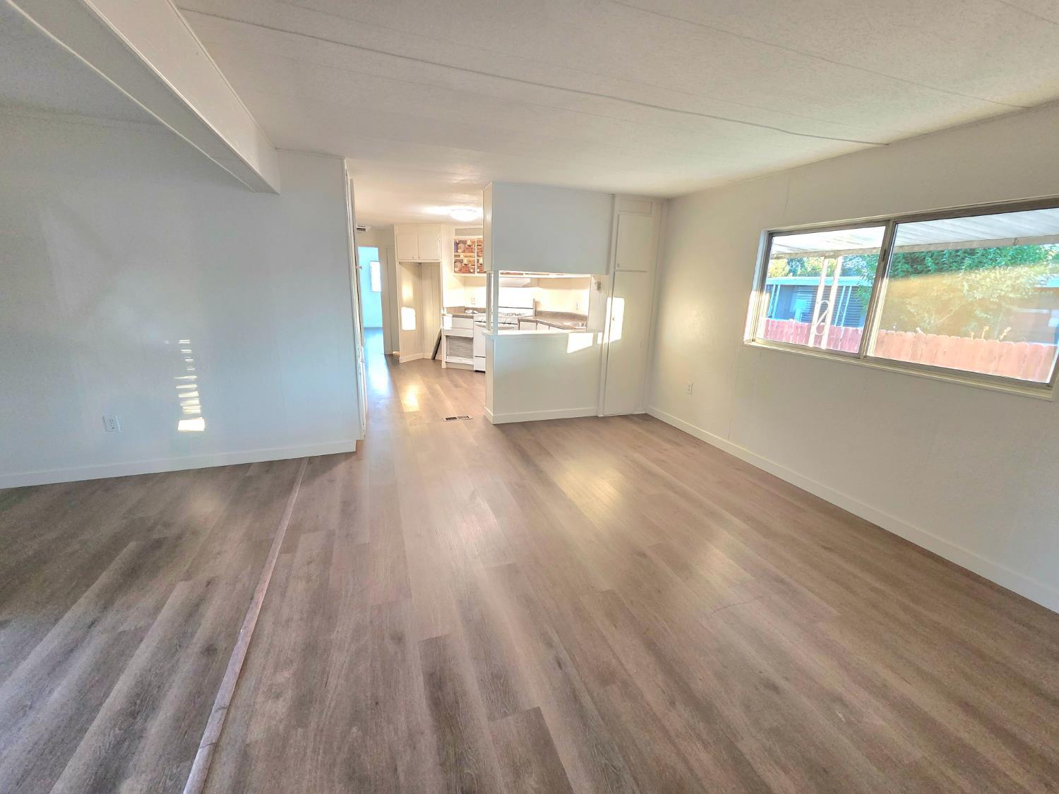 5200 Cavitt Stallman Road, Unit 1 Granite Bay, CA 95746 - Photo 18 of 41 a view of a big room with wooden floor a kitchen view and windows