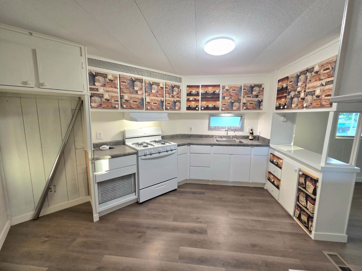 5200 Cavitt Stallman Road, Unit 1 Granite Bay, CA 95746 - Photo 19 of 41 a kitchen with stainless steel appliances a white stove top oven sink and cabinets