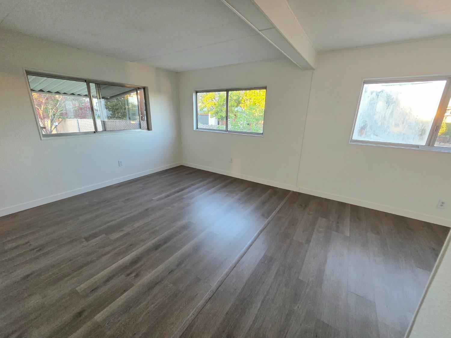 5200 Cavitt Stallman Road, Unit 1 Granite Bay, CA 95746 - Photo 27 of 41 a view of an empty room with wooden floor and a window