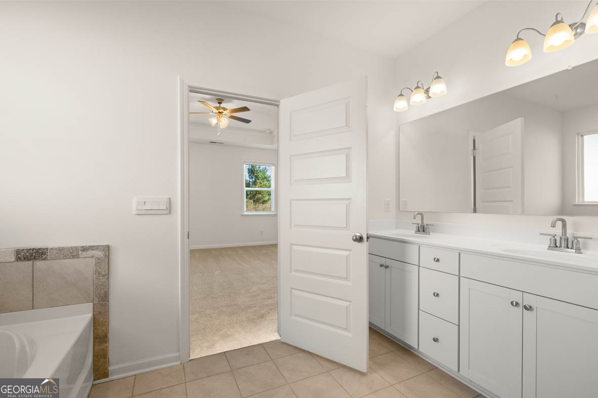 1801 Quaker Hampton, GA 30228 - Photo 13 of 37 a spacious bathroom with a double vanity sink a mirror and a bathtub
