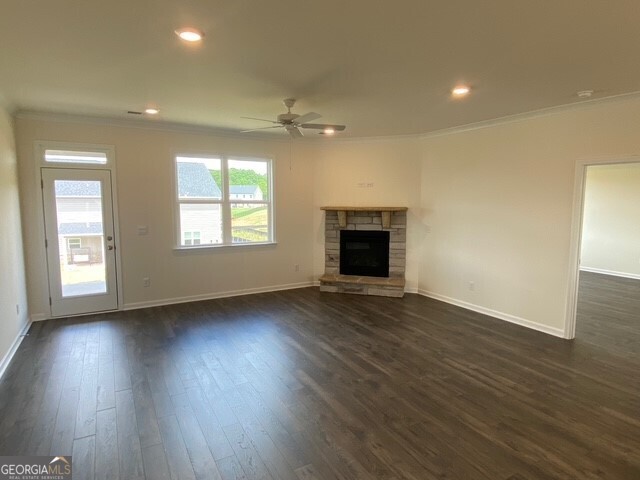 1801 Quaker Hampton, GA 30228 - Photo 28 of 37 an empty room with wooden floor fireplace and windows