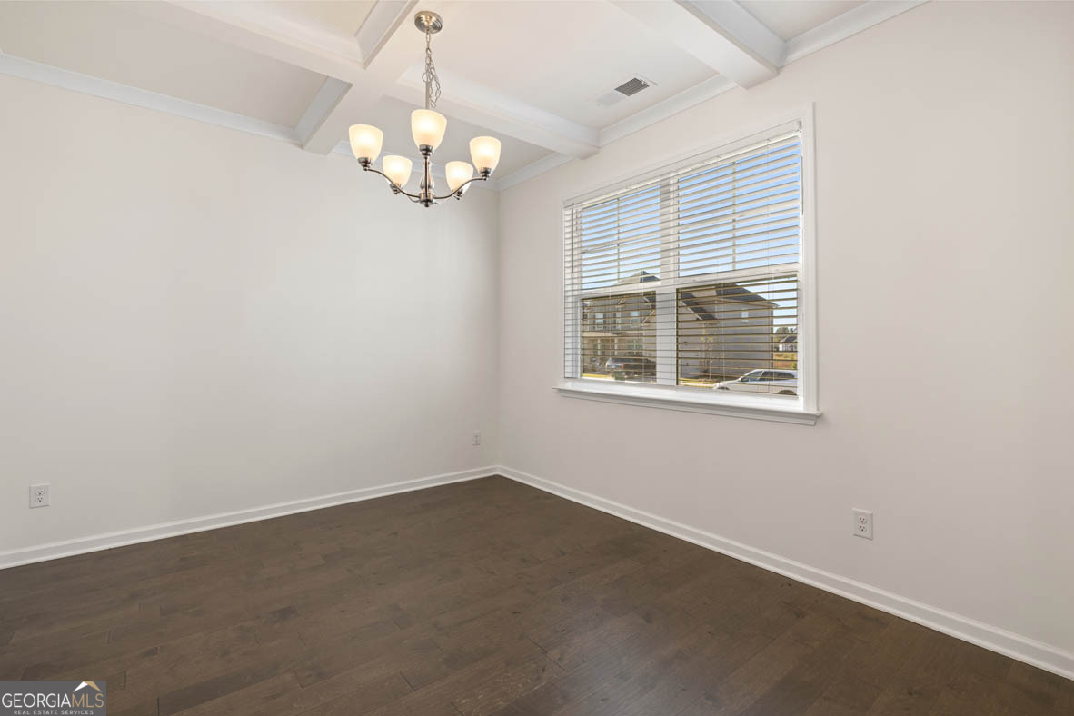 1801 Quaker Hampton, GA 30228 - Photo 9 of 37 en empty room with windows and chandelier