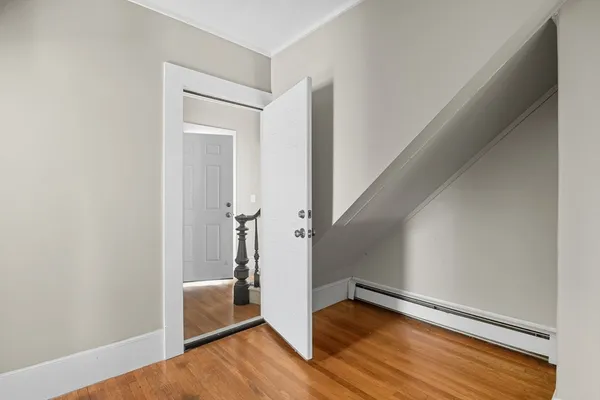 a view of hallway with stairs and wooden floor