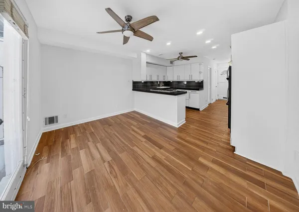 a kitchen with stainless steel appliances a sink and a refrigerator