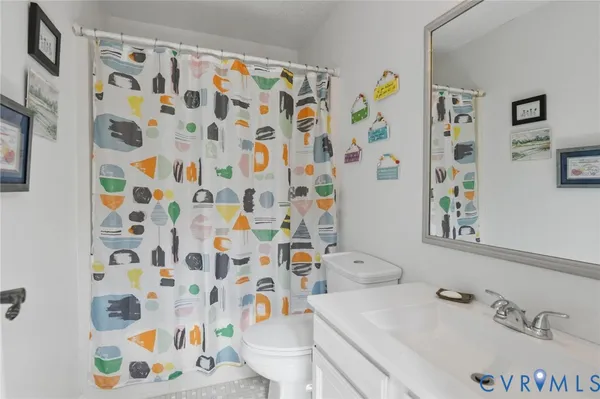 a view of a room with a large bed and wooden floor