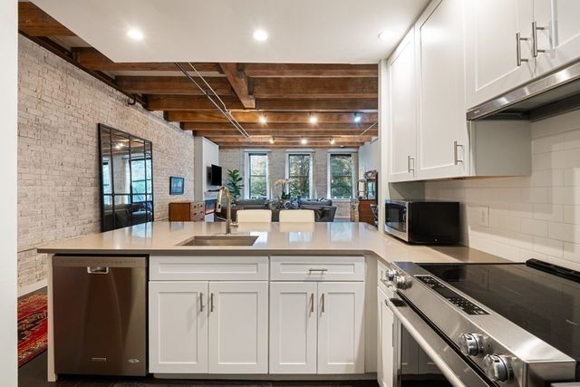 a kitchen with cabinets appliances and a counter top