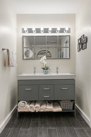 a bathroom with a toilet a sink and a mirror