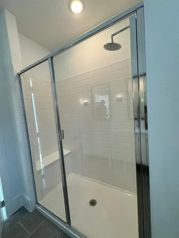 a spacious bathroom with a double vanity sink and a mirror