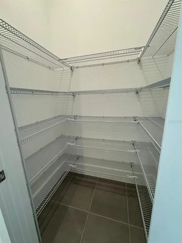 a small space with a shower and a table