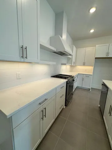 a kitchen with cabinets and white stainless steel appliances
