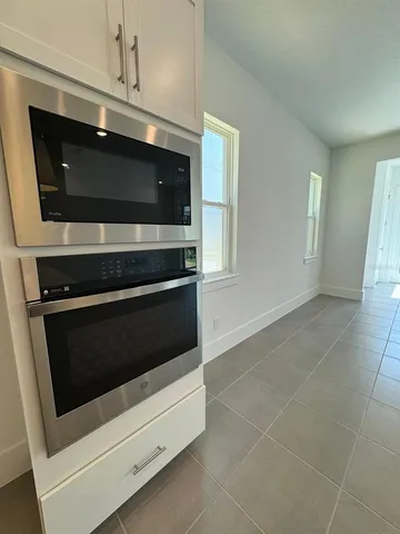 a stove top oven sitting inside of a kitchen