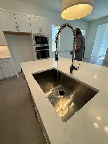 a kitchen with a sink and a stove