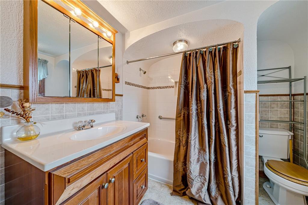 2375 Mt Pleasant Road Ruffs Dale, PA 15679 - Photo 24 of 31 a bathroom with a sink a mirror and a bathtub