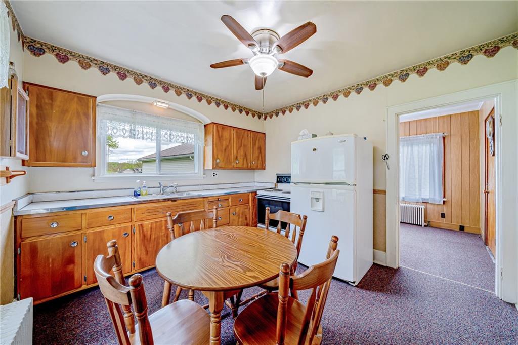 2375 Mt Pleasant Road Ruffs Dale, PA 15679 - Photo 8 of 31 a kitchen with stainless steel appliances granite countertop a dining table chairs sink and cabinets